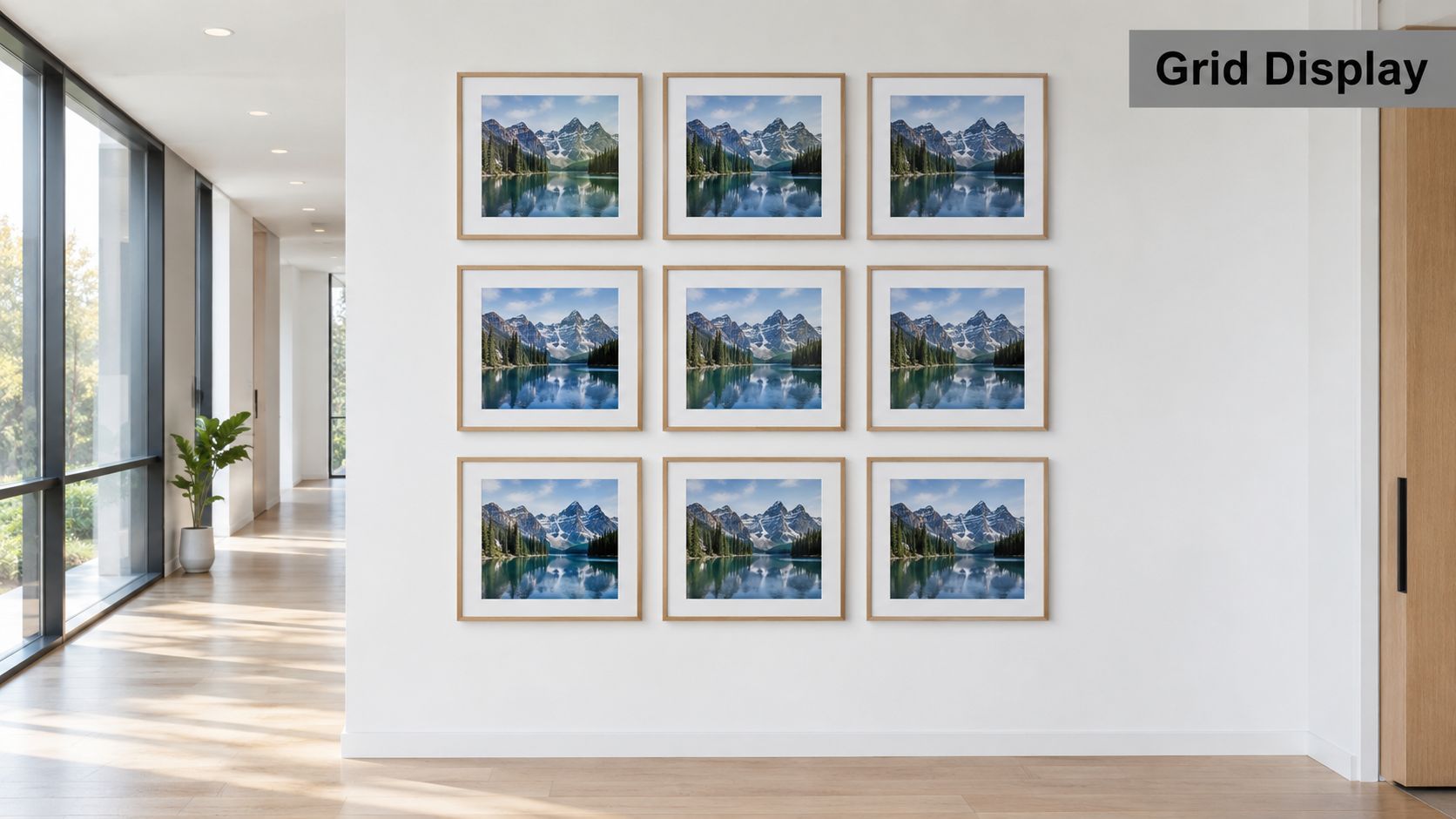 A modern hallway wall featuring a grid display of nine identical framed mountain landscape photographs.