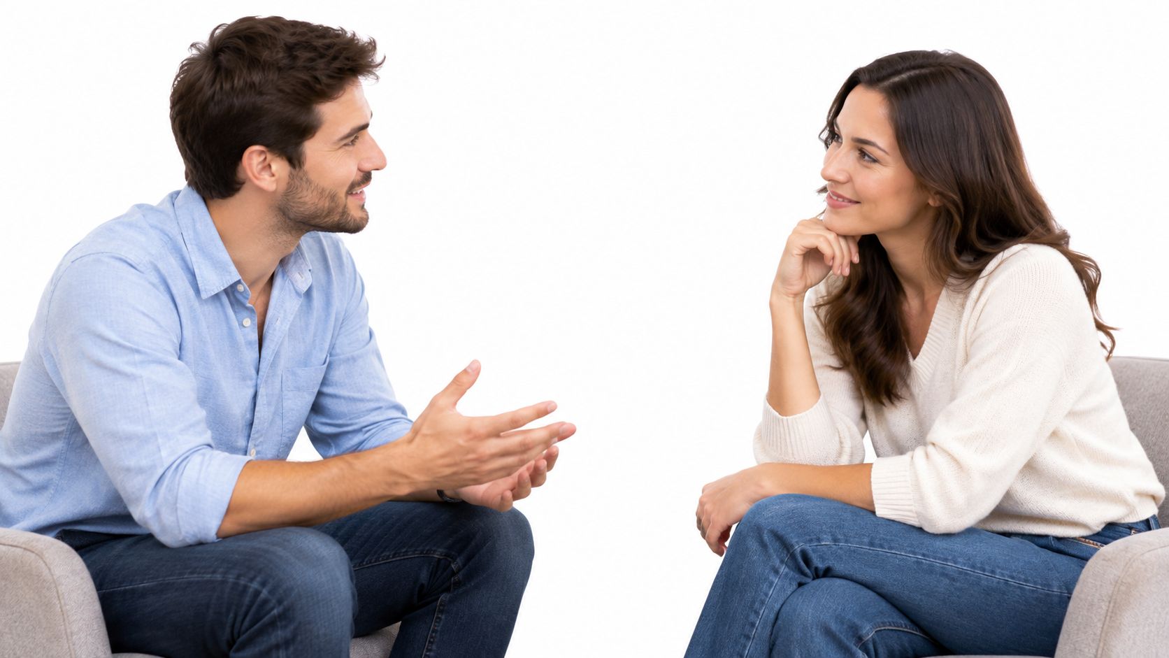 A man and a woman sitting in chairs across from each other having an engaging conversation