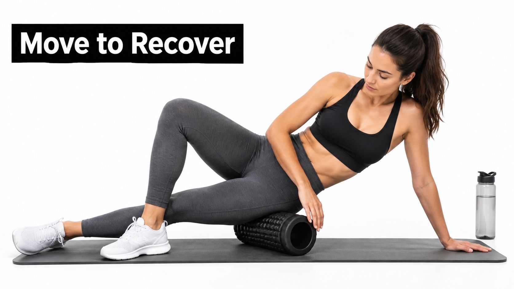 A fit woman using a black foam roller to massage her thigh muscles while on a yoga mat.