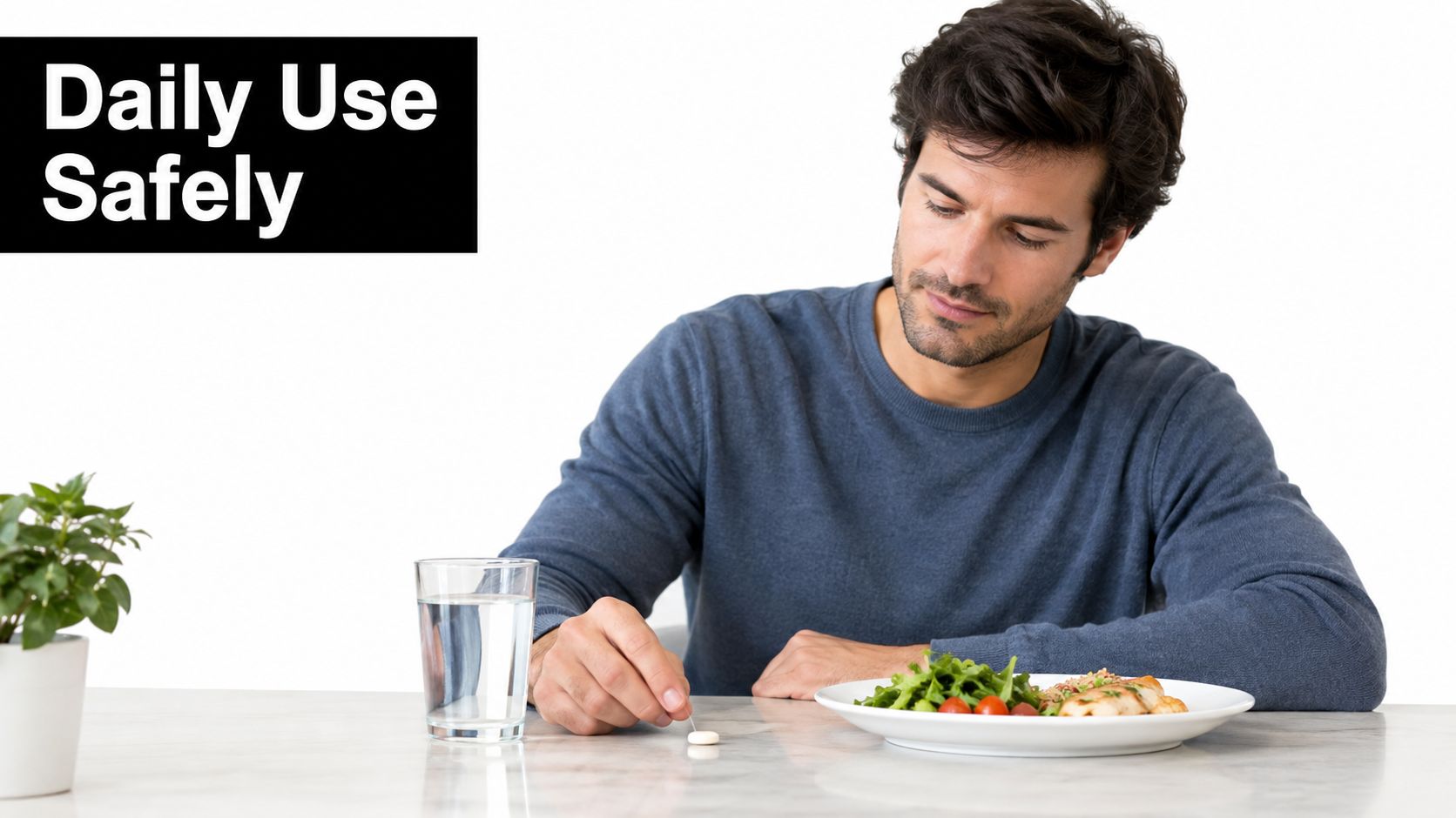 A man in a blue sweater sits at a table preparing to take a dietary supplement pill.