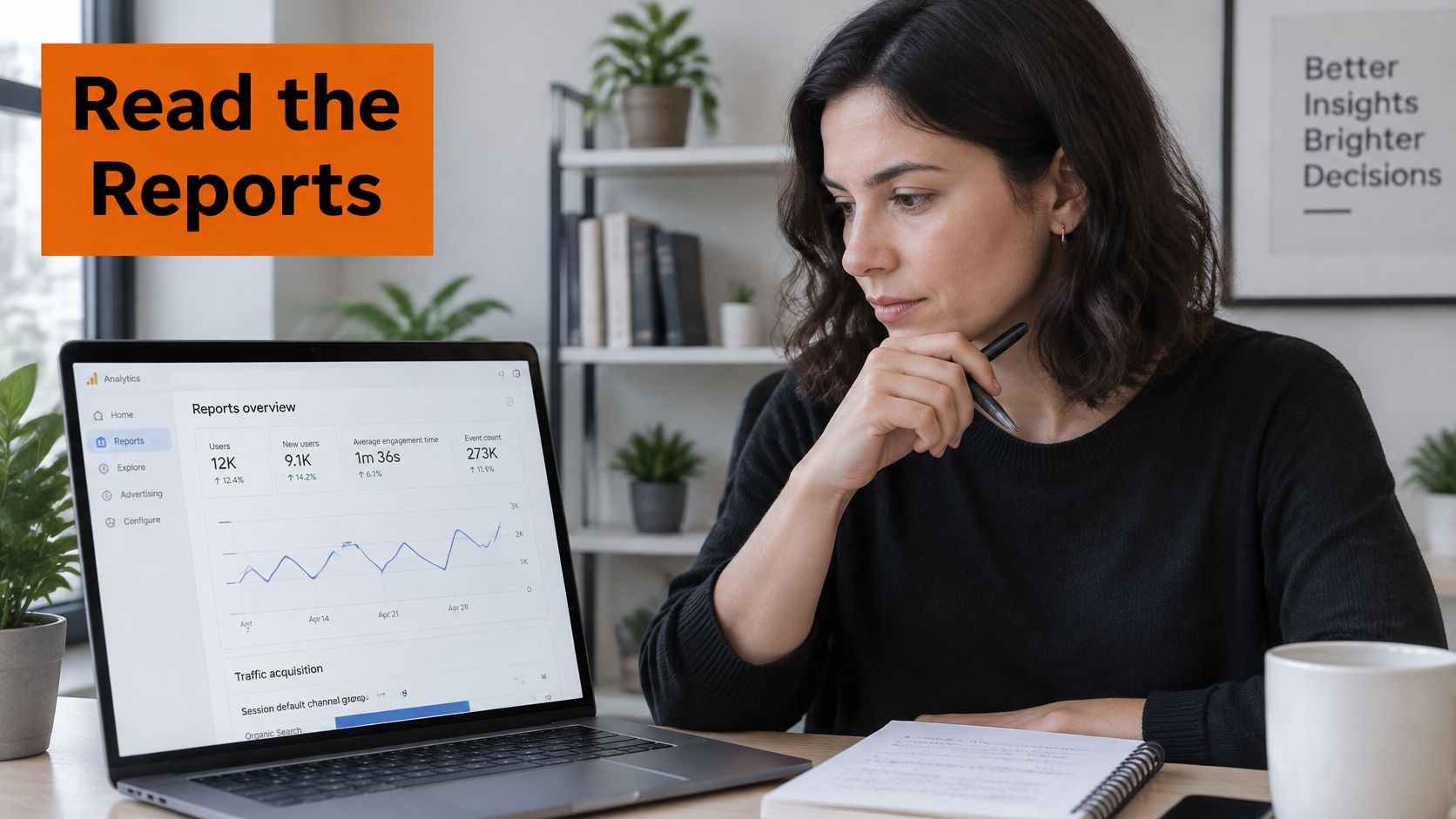 A professional woman analyzing website data reports on her laptop while sitting at a bright desk.