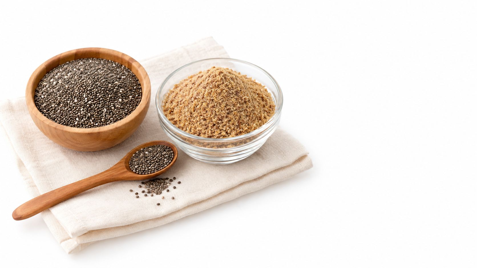 A wooden bowl and a wooden spoon of chia seeds alongside a bowl of ground flaxseeds.
