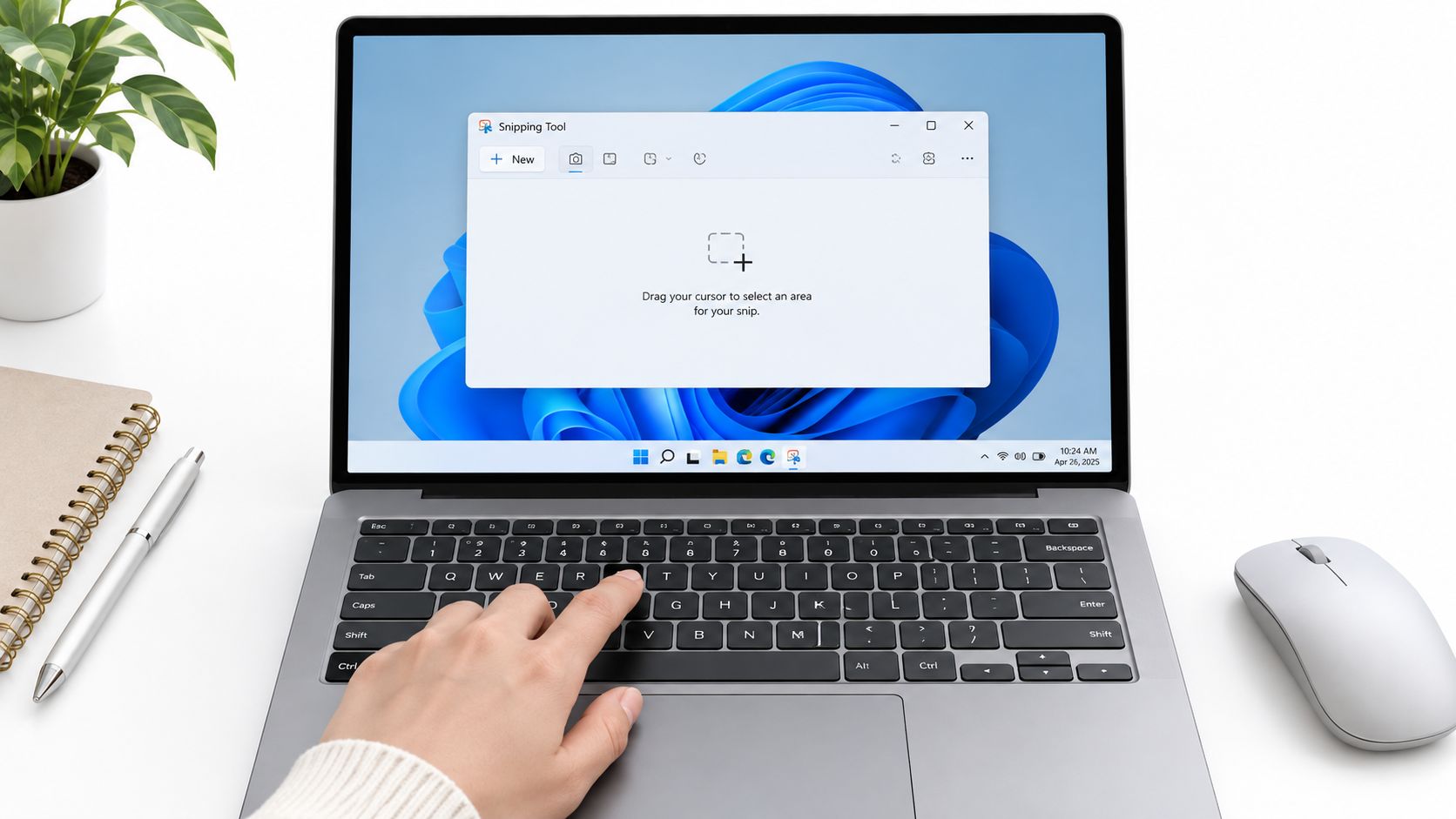 A person using a laptop keyboard to take a screenshot using the Windows Snipping Tool application.