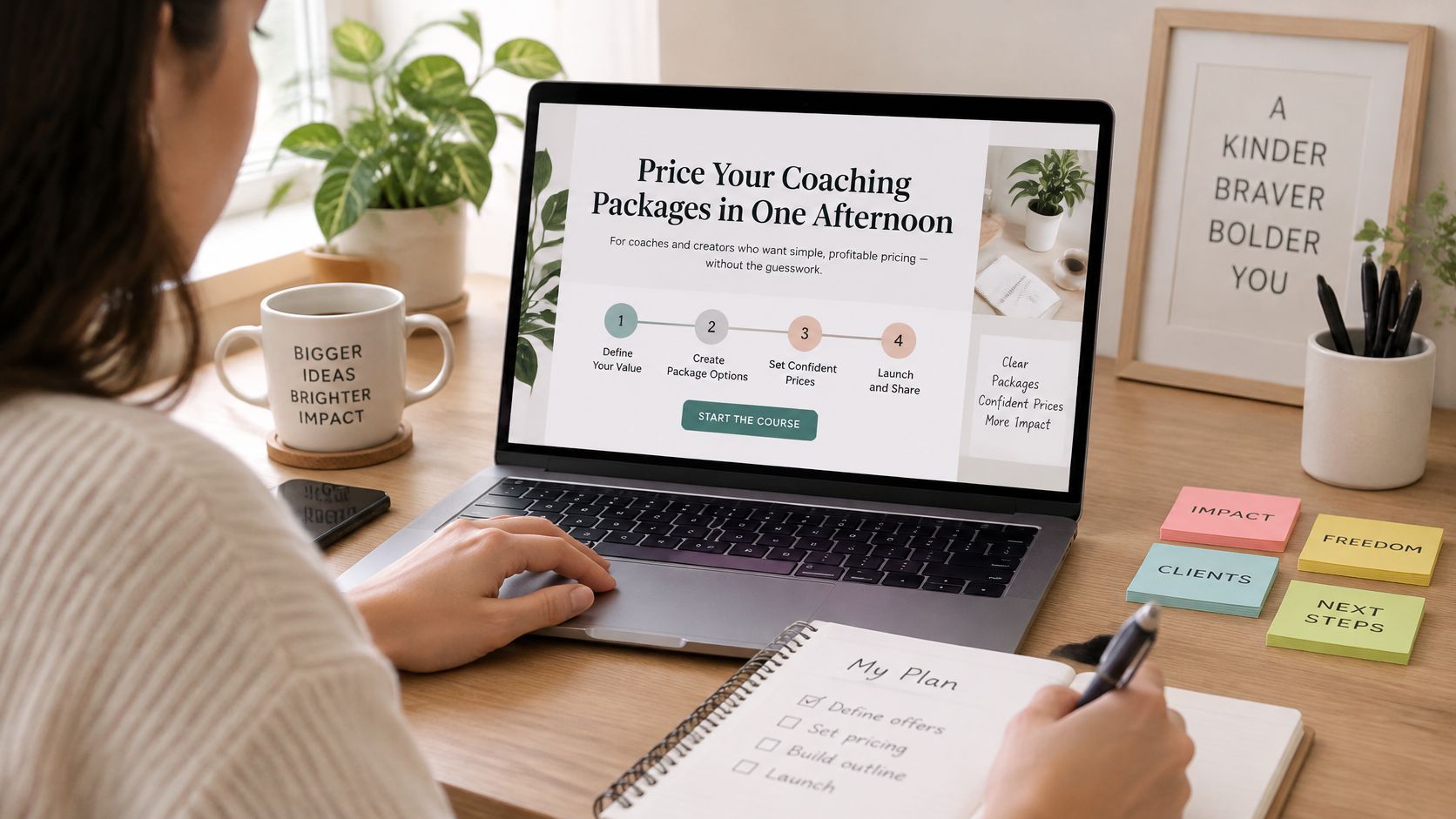 A woman working at a wooden desk on a laptop displaying a course on pricing coaching packages.