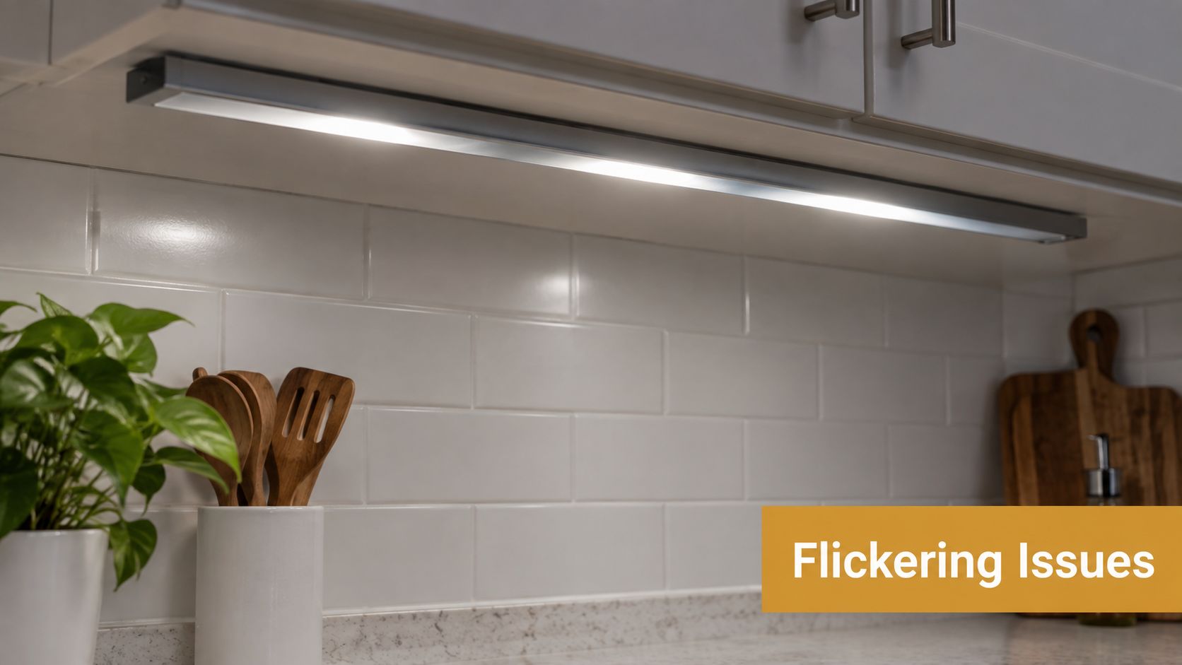 A modern LED light strip installed under kitchen cabinets casting bright light on white tiled backsplash.