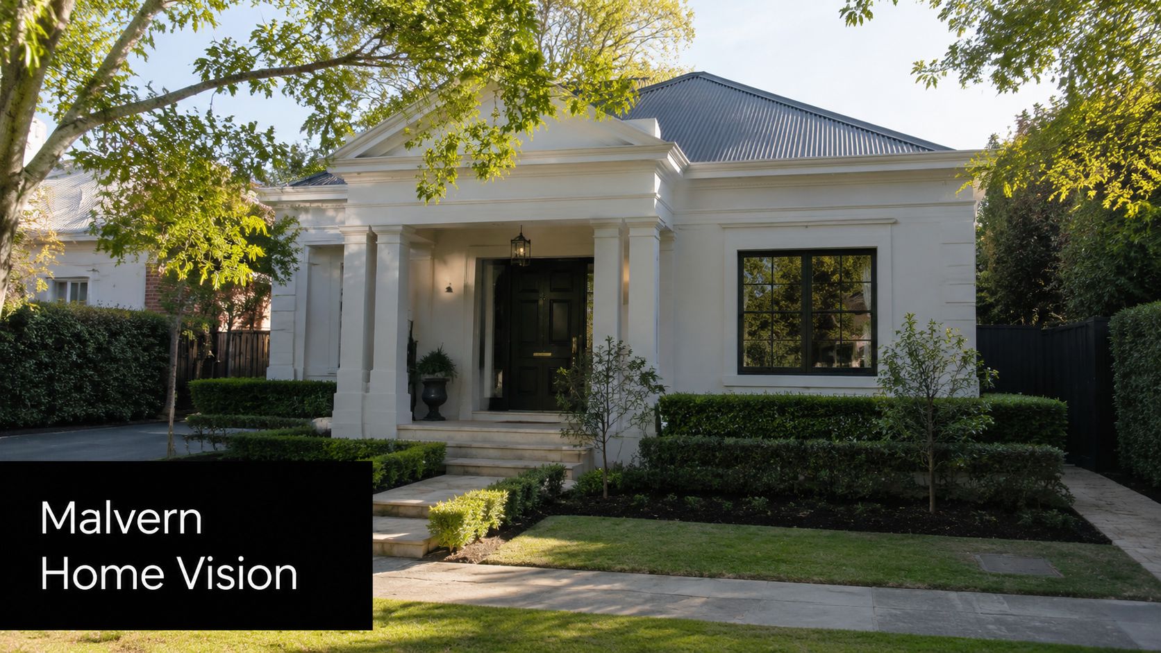 A luxurious white neoclassical house in Malvern with a manicured front garden and a black front door.