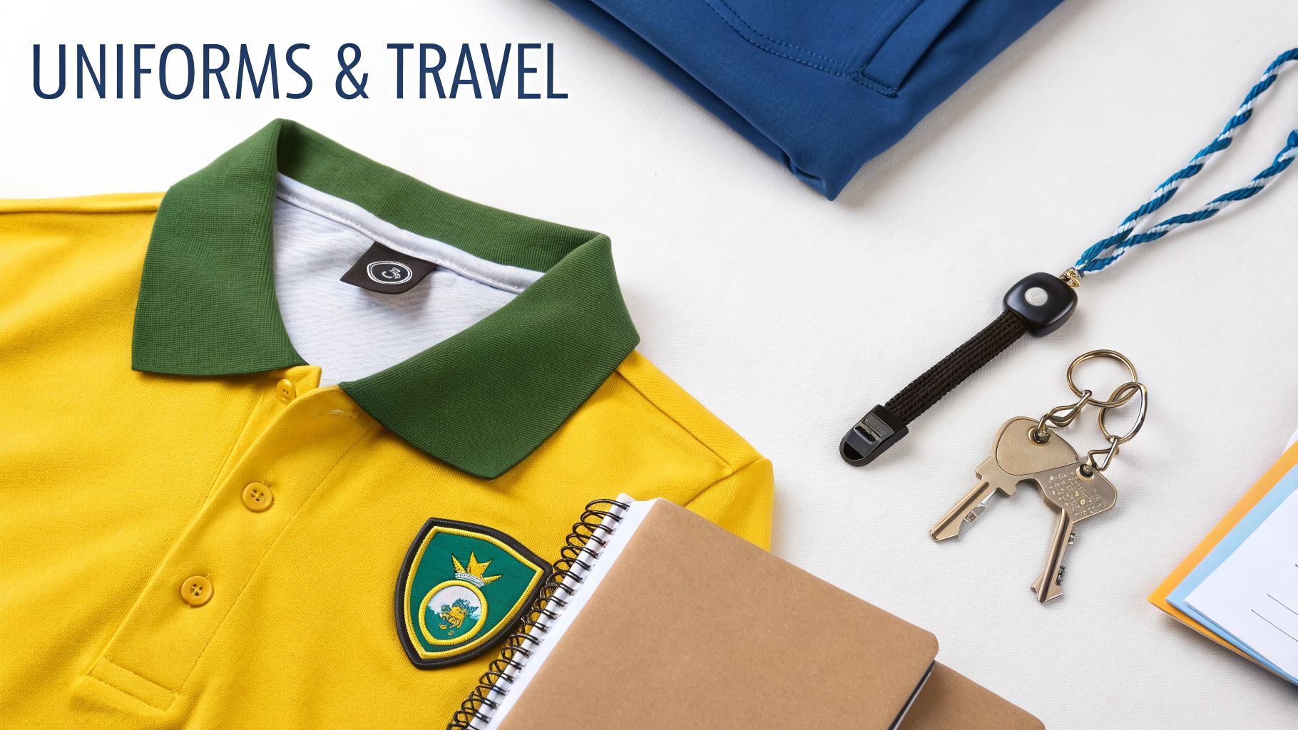 A yellow polo shirt with a green collar and crest, lanyard, keys, and notebook, symbolizing uniforms and travel.