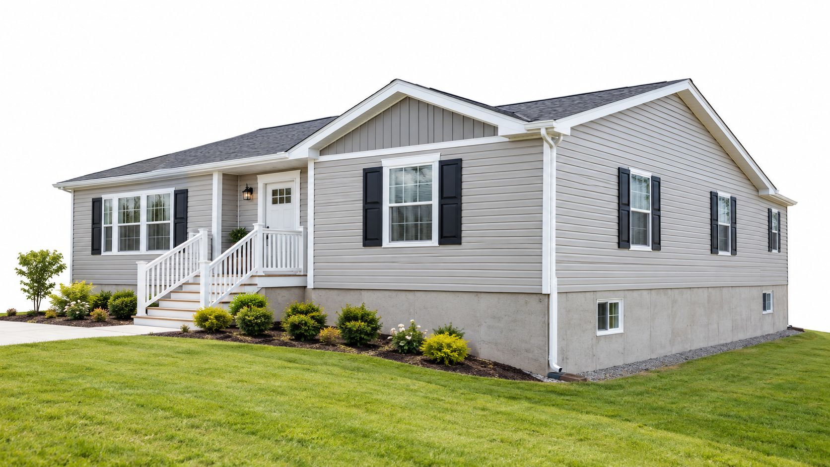 A modern light gray modular home featuring a concrete foundation and landscaped front yard with green lawn.