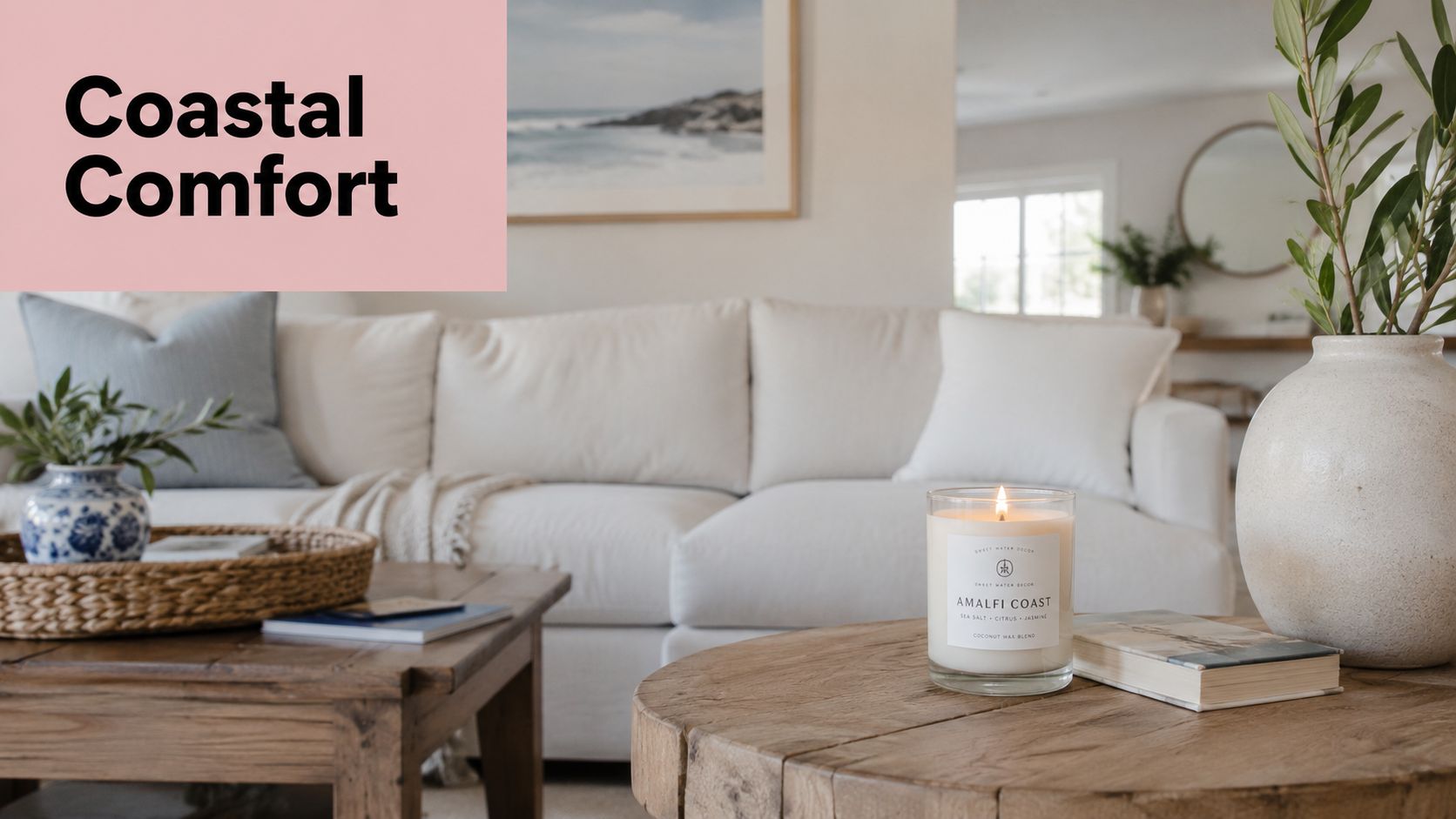 A cozy coastal living room featuring a lit candle, wooden coffee table, and soft white sofa.