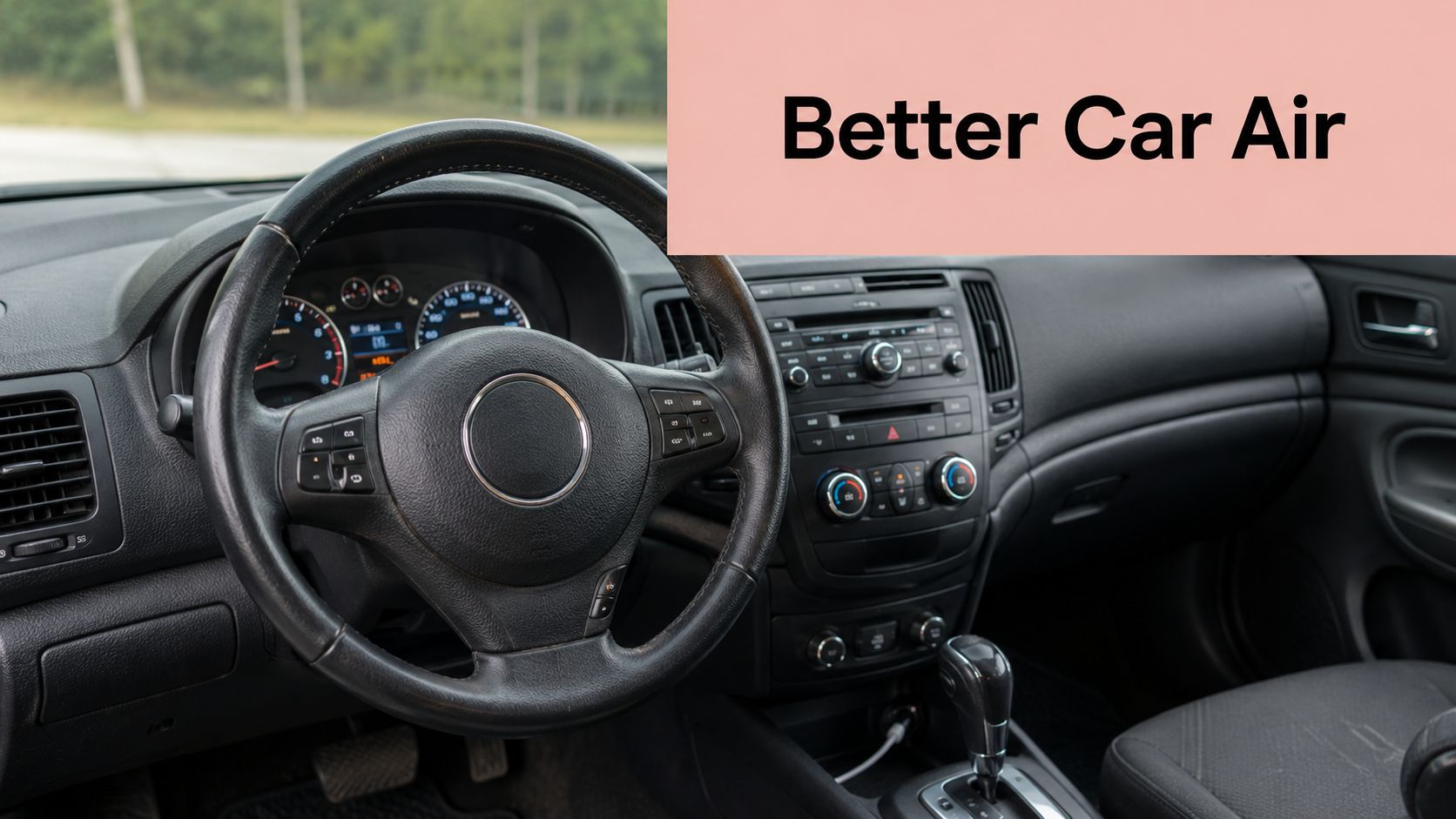 A view inside a car interior featuring the steering wheel, dashboard, and center console air conditioning controls.