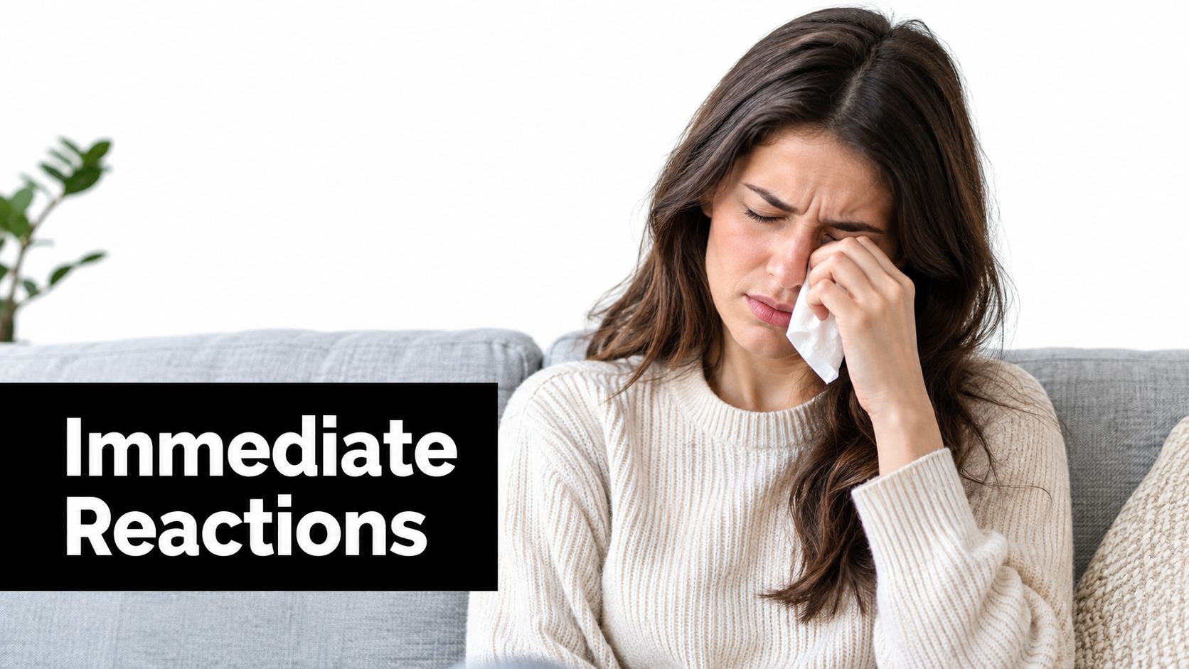 A woman crying on a sofa while holding a tissue, representing the negative health impacts of poor indoor air.
