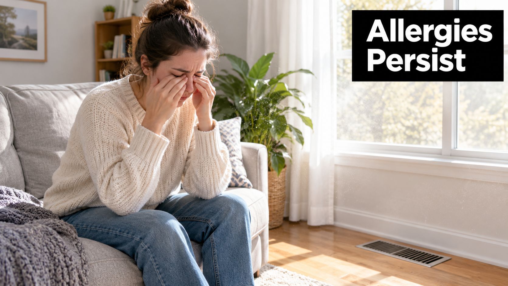 A woman sitting on a couch touching her eyes in discomfort due to indoor air quality allergies.