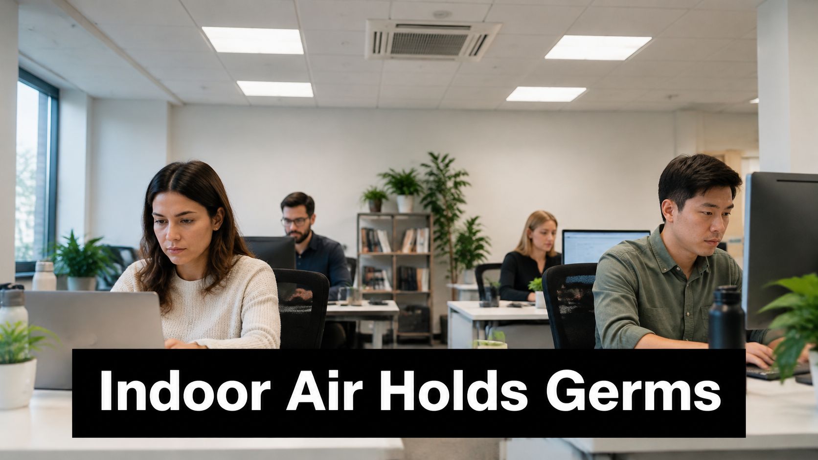 A diverse group of colleagues working at their desks in a bright, modern open-plan office setting.